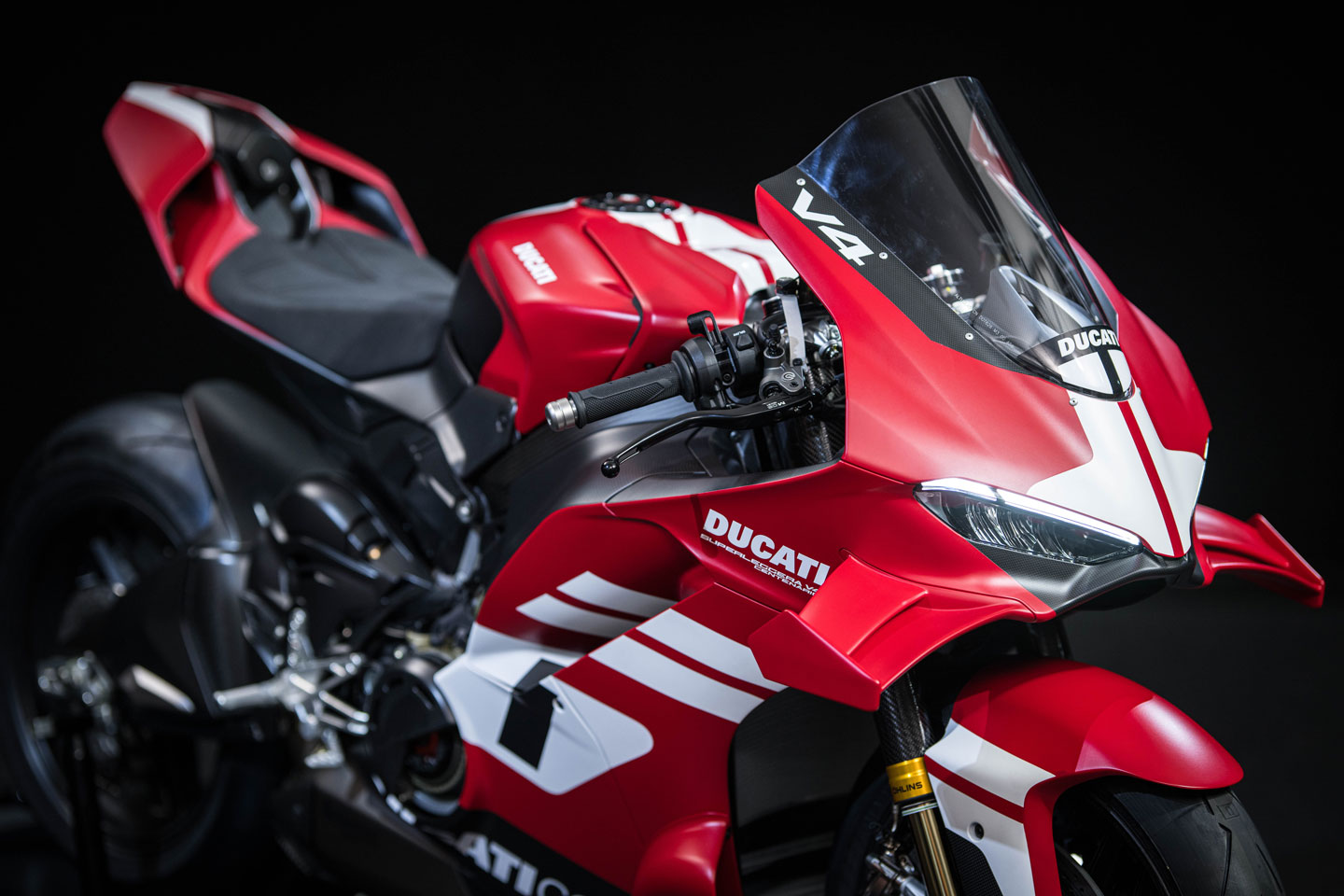 The Centenario showcases its extensive carbon fiber construction and WorldSBK-derived aerodynamics, a testament to Ducati's engineering.