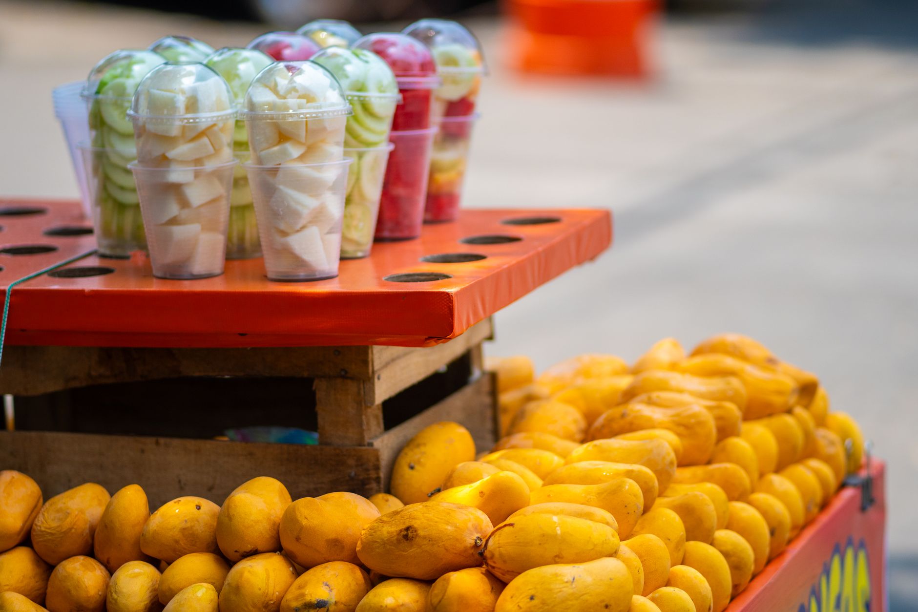A vibrant street food scene showcasing a blend of global comfort dishes, from spicy Korean buldak to refreshing Indian falooda, reflecting the diverse culinary landscape of 2027.